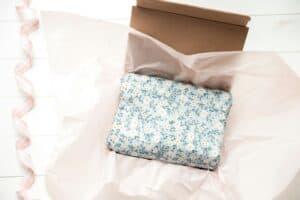 wrapping fragile item with tissue and bubble wrap