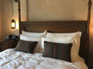 hotel bed overloaded with decorative pillows