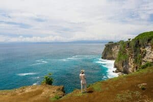 “tourist dangerously close cliff edge panorama