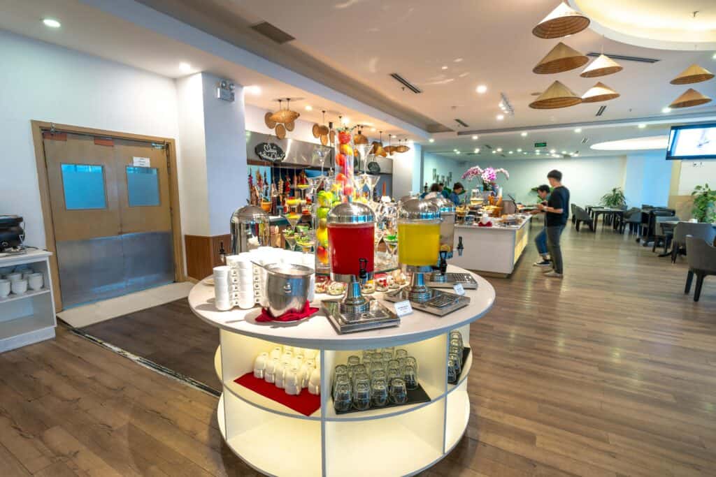 hotel breakfast buffet spreading trays cereal coffee juice hotel dining room”