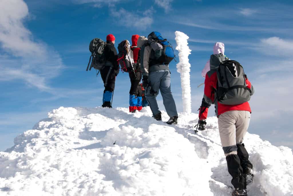 “mountain trekking group at high altitude snow alpine pass”