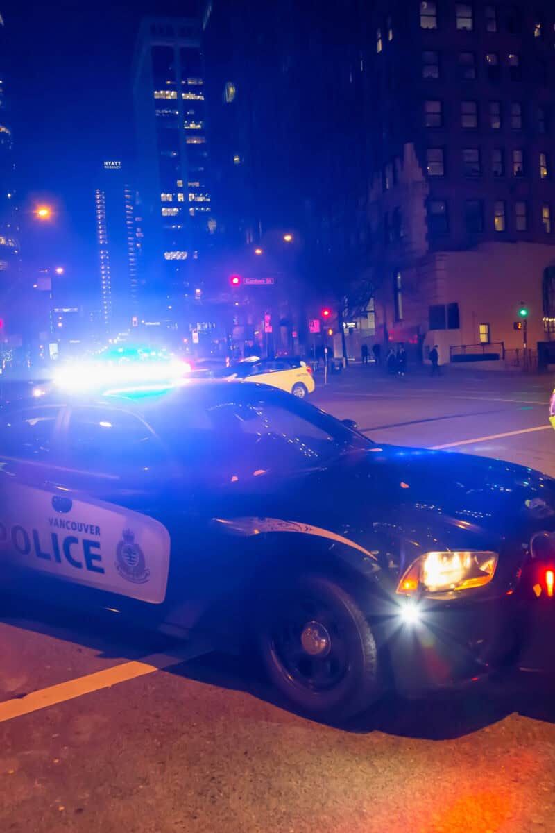 police cruiser night city street”