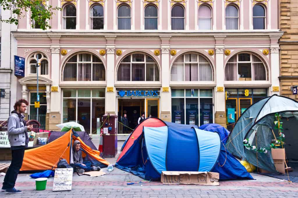small tourist town street at dusk with tents by sidewalk