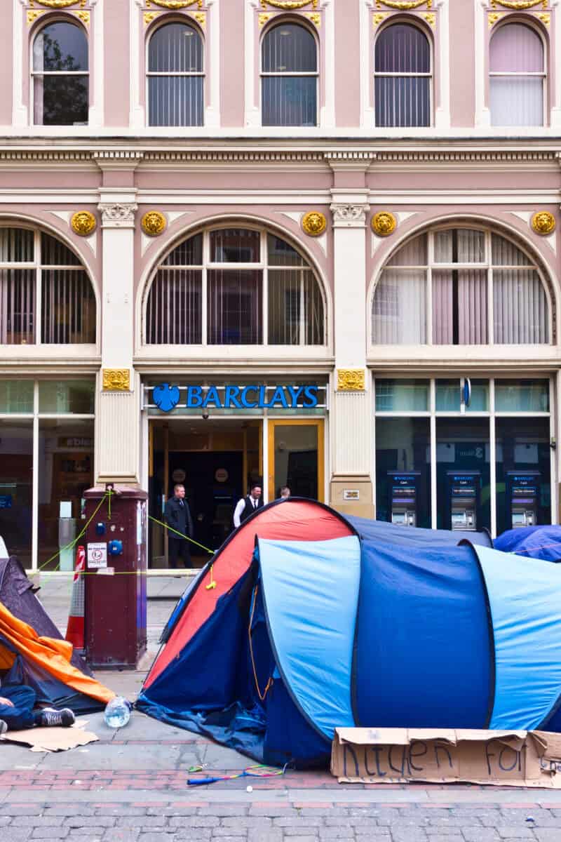 small tourist town street at dusk with tents by sidewalk