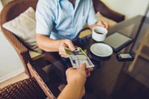 global tipping culture contrast restaurant bill tourist paying restaurant bill abroad card machine credit card terminal tip prompt travel dining restaurant bill close up tip section international