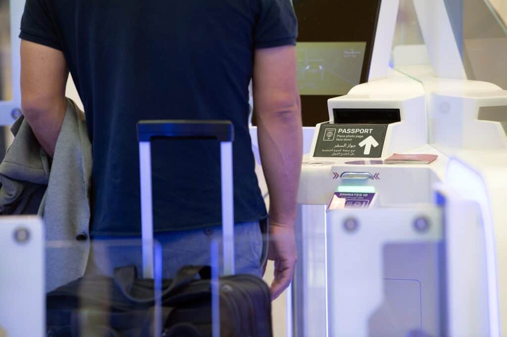 international travelers arriving at airport passport control"