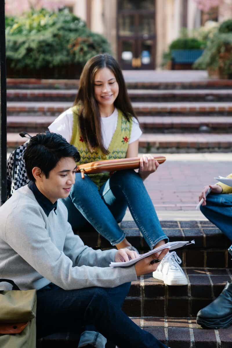 Photograph of a Group of Friends Sitting on Brick Steps