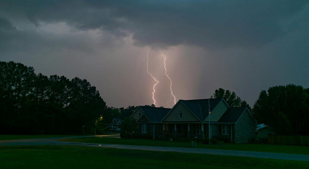 suburban home under dark storm clouds with clipboard inspection