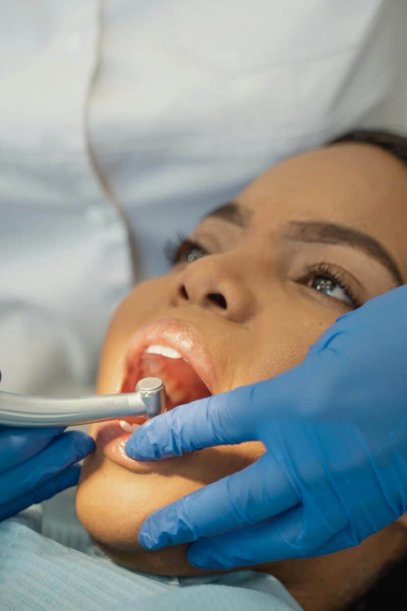 dentist using dental grinder on a patient