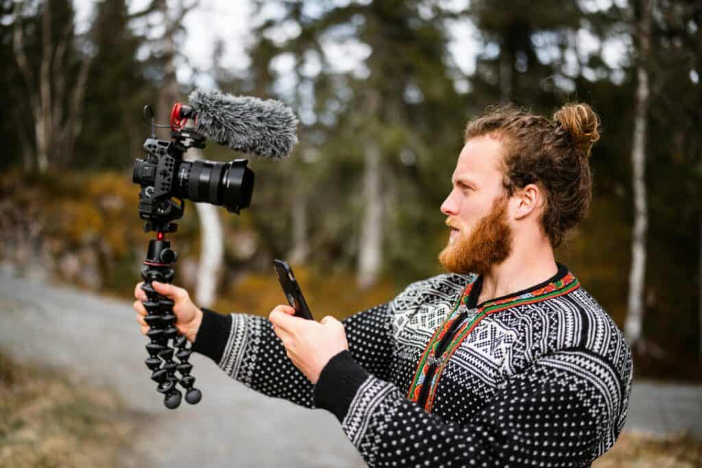 content creator filming travel phone tripod lifestyle"