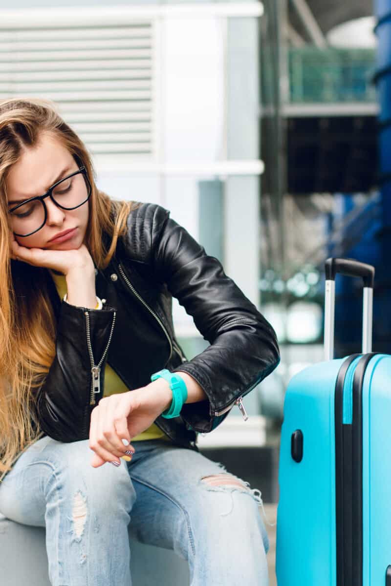 traveler stressed at airport check in counter luggage