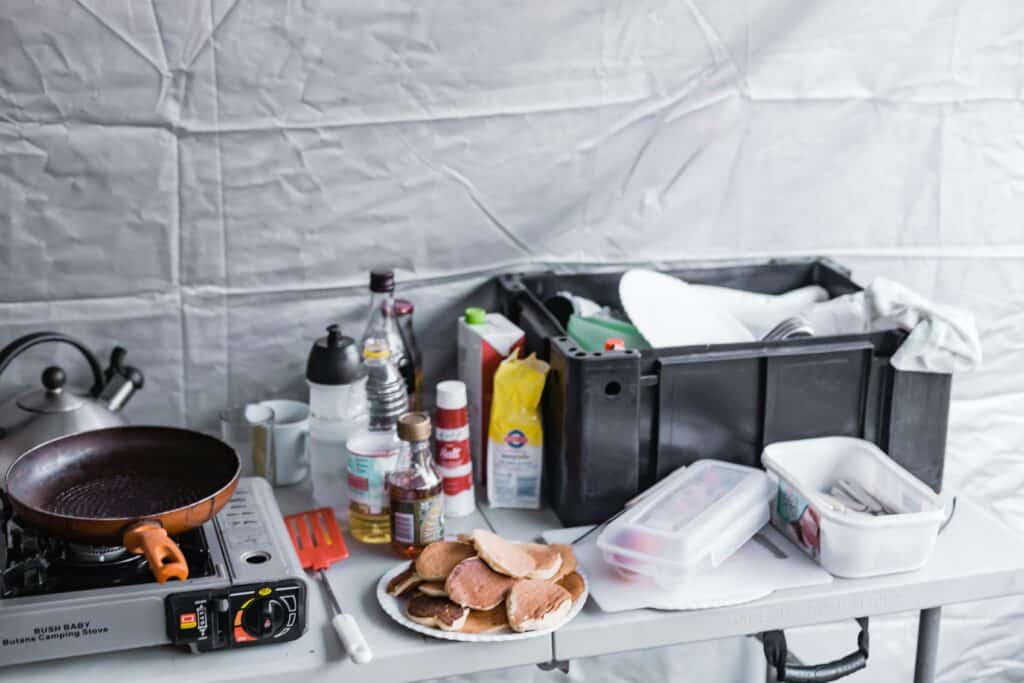 compact backpacking setup next to large U.S. camp kitchen