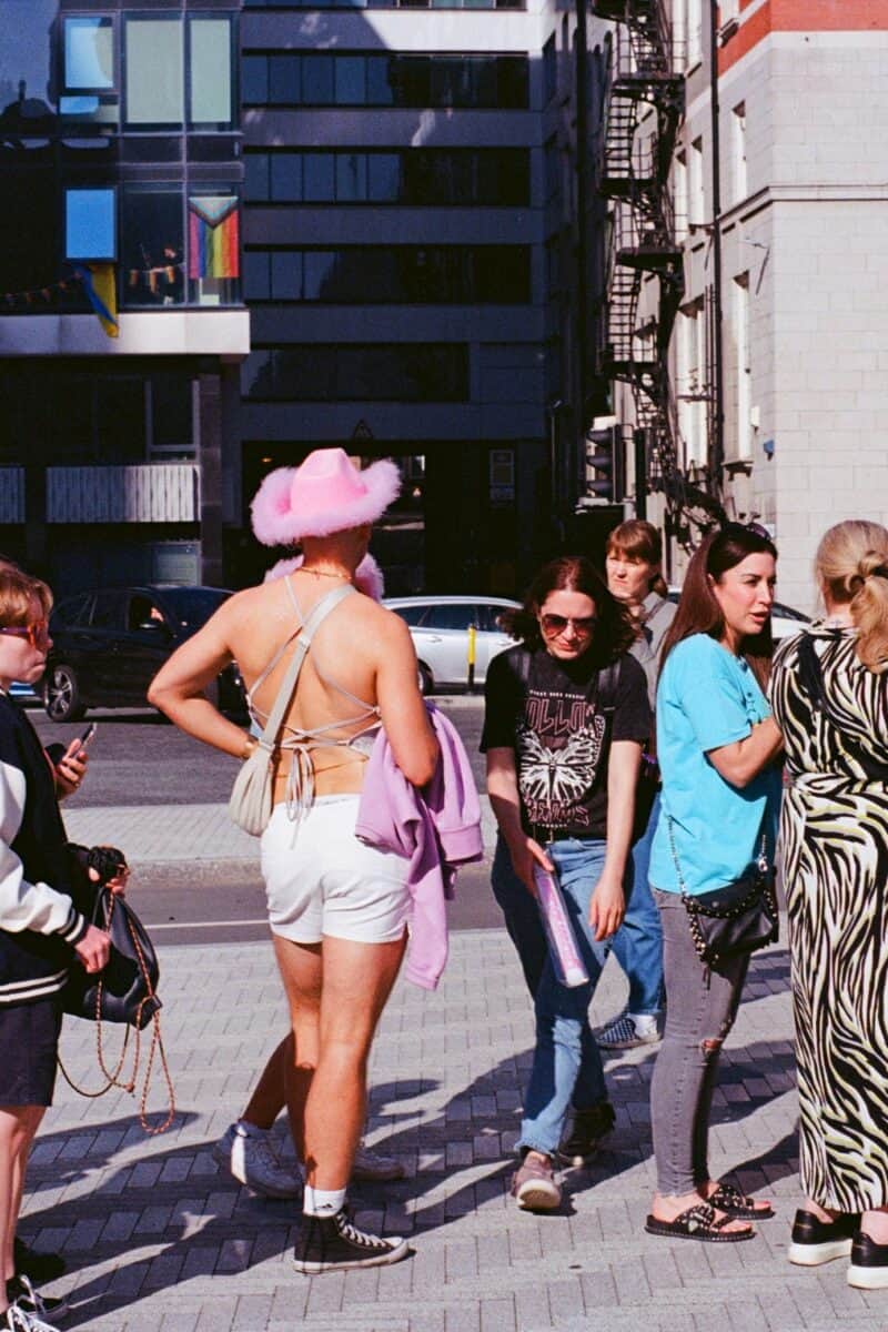 “tourists and locals crowded city street”