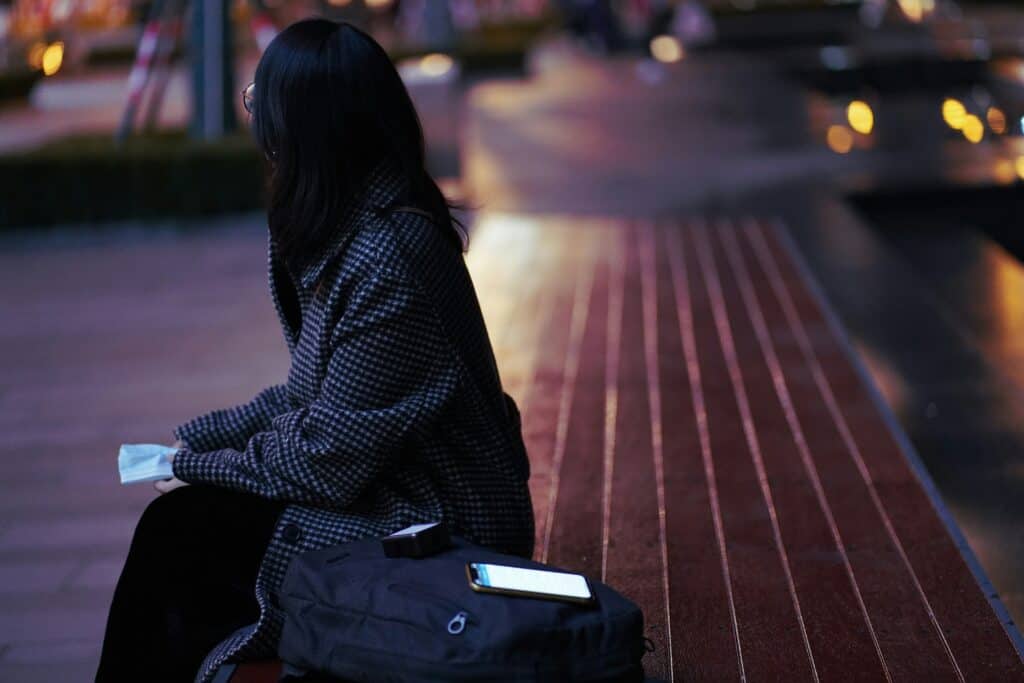 solo female traveler city street evening
