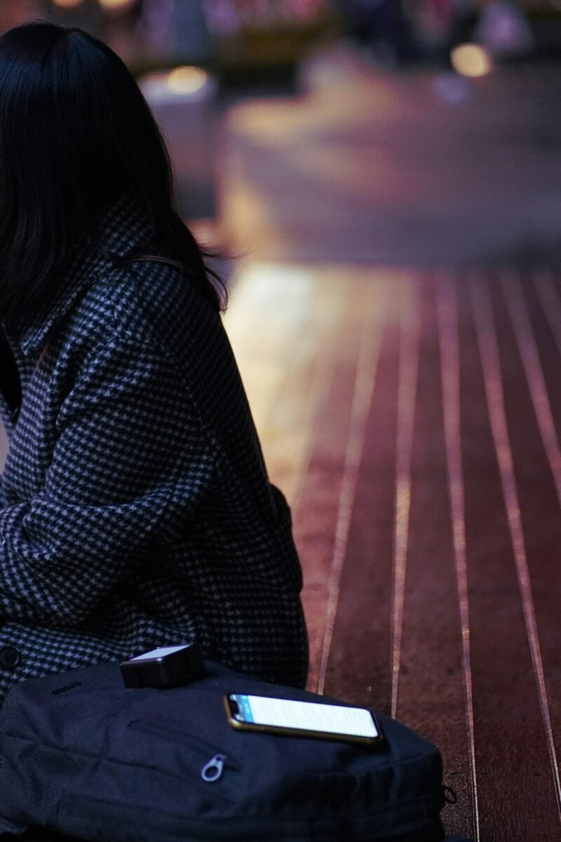 solo female traveler city street evening