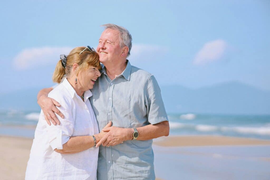 retiree couple walking seaside town