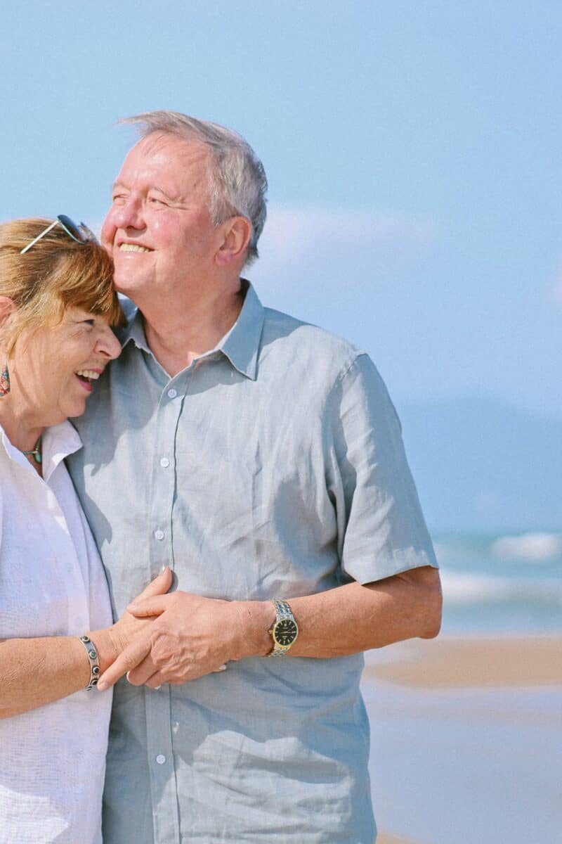 retiree couple walking seaside town