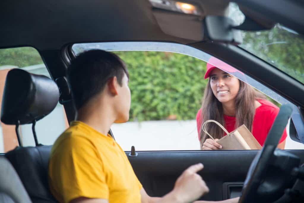 Women Talking to the Person Inside the Car