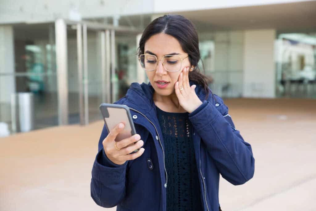 traveler stressed phone airport