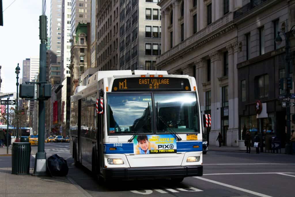 city bus idling curbside