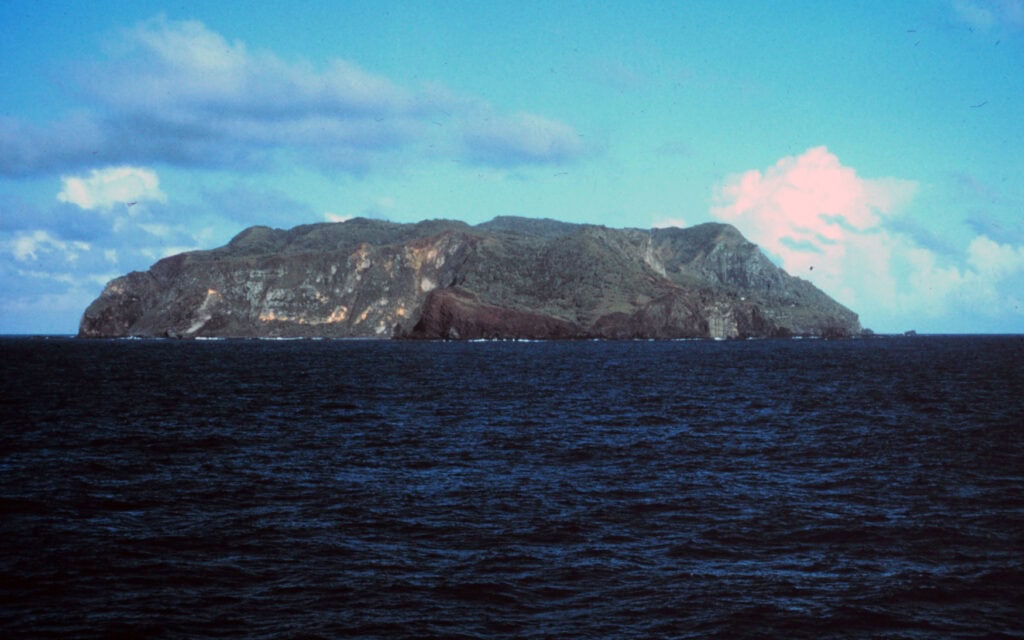 Pitcairn Island steep cliffs Pacific waves stormy sea