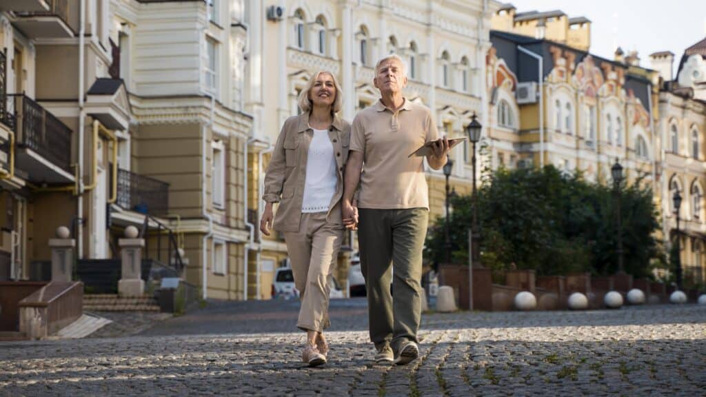 front-view-elder-couple-out-walk-city-with-tablet