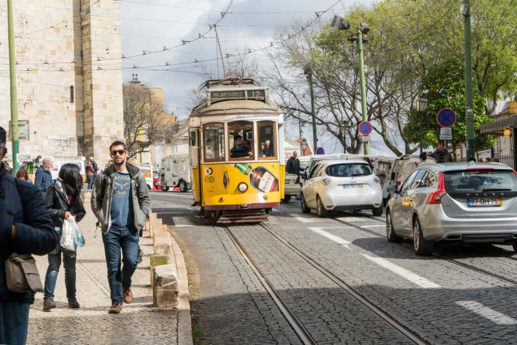 Lisbon tram crowded tourists Alfama
