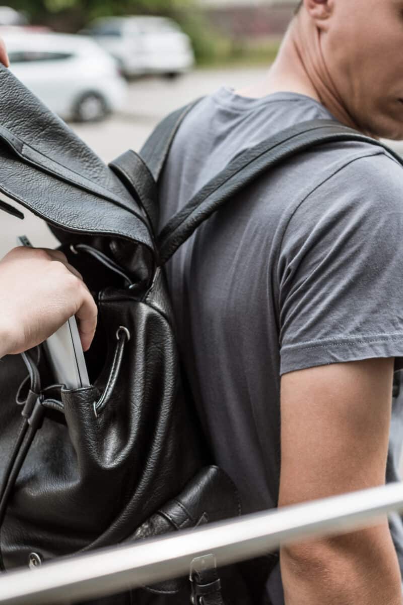 open backpack zipper crowded street theft