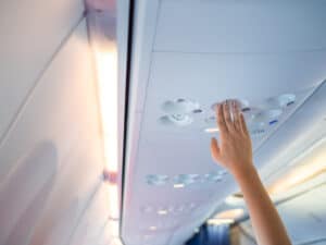 airplane passenger pressing call button