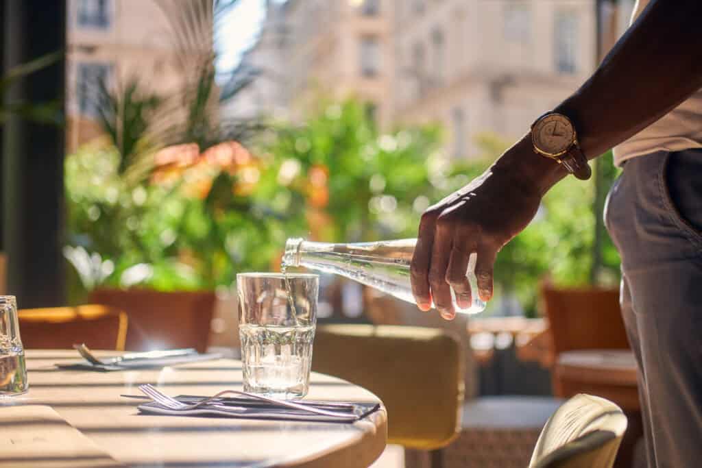 glass bottle water restaurant europe table