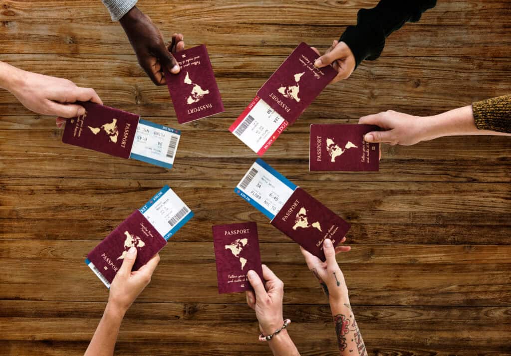 Group of Diverse Friendship Hands Show Passport with Plane Ticket