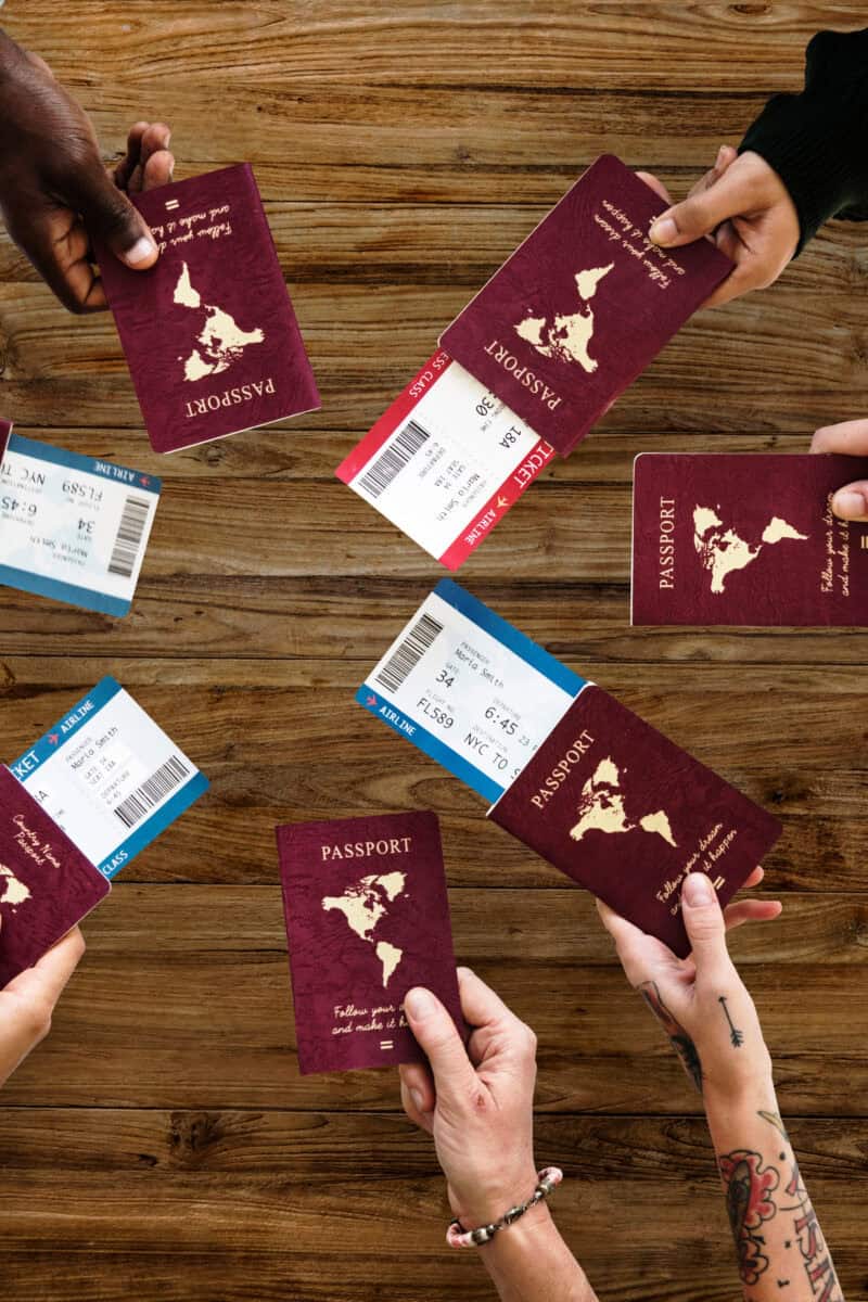 Group of Diverse Friendship Hands Show Passport with Plane Ticket