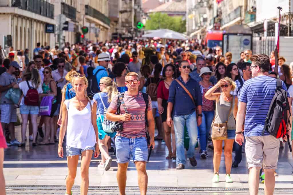 crowded European city street tourists summer