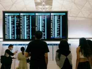 confused passengers airport information screen