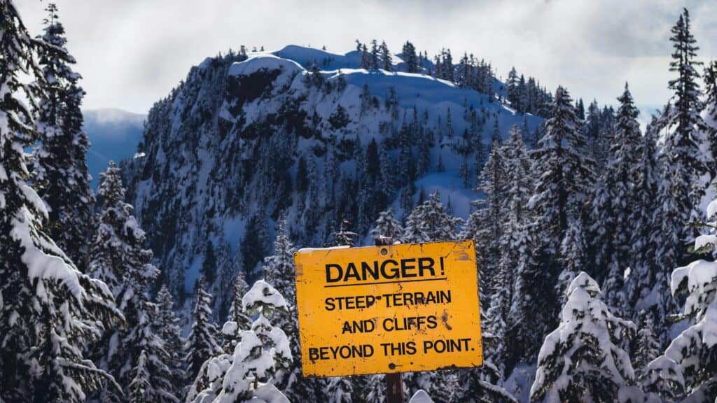 tourists ignoring warning sign cliff
