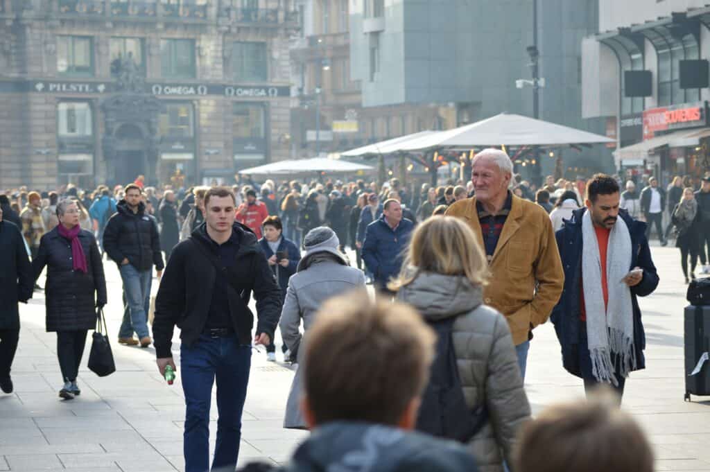 autumn tourists European city street crowd