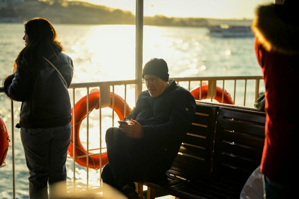 passenger using phone cruise ship deck