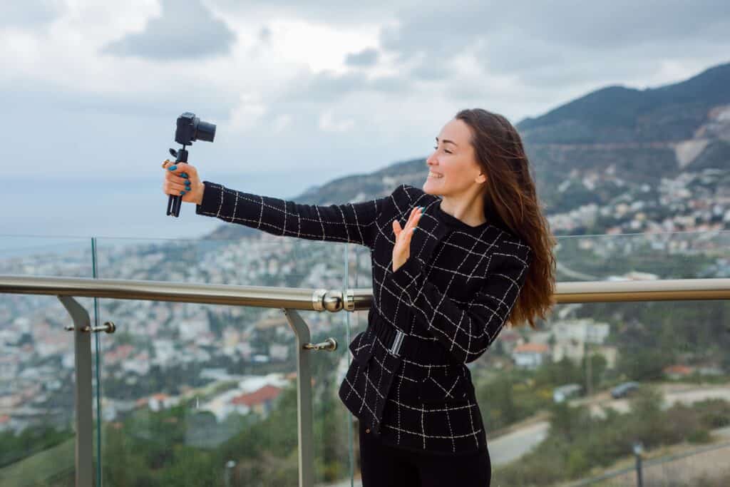 influencer taking photo scenic viewpoint tripod