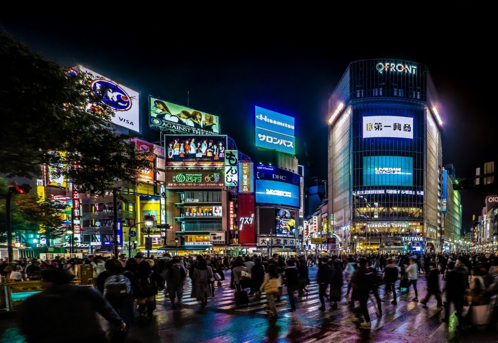 Shibuya crossing Tokyo night neon crowd