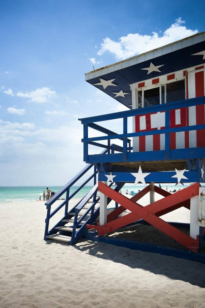 Colorful lifeguard tower with American flag design on Miami Beach.