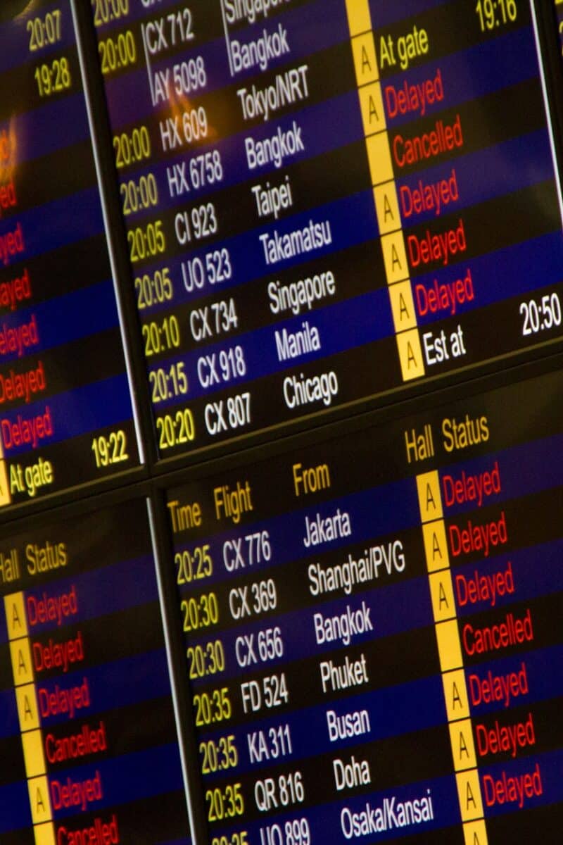 Close-up of digital flight information board showing arrivals and departures at an airport.