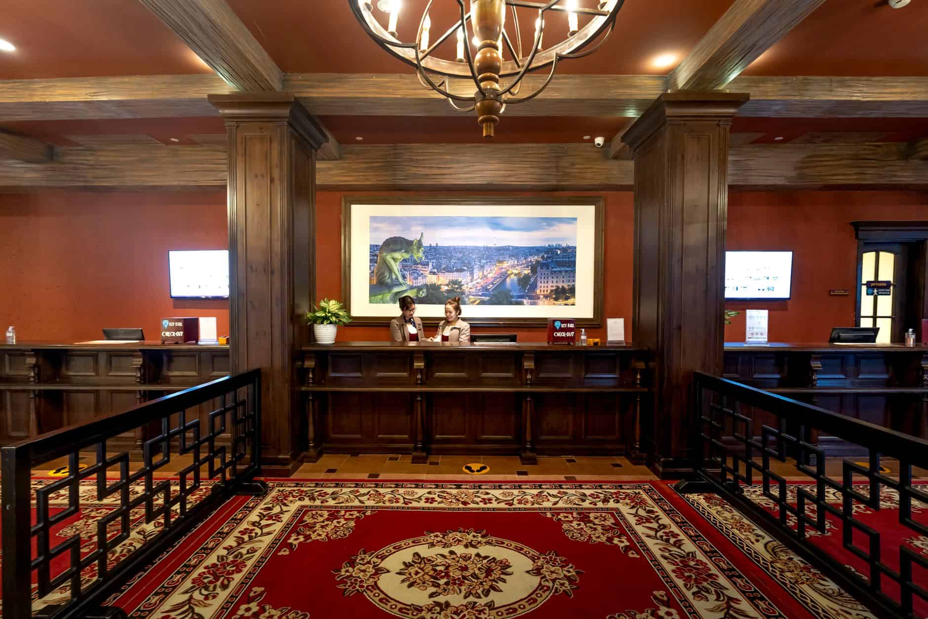 Elegant and luxurious hotel reception with classic wooden design and plush carpeting.