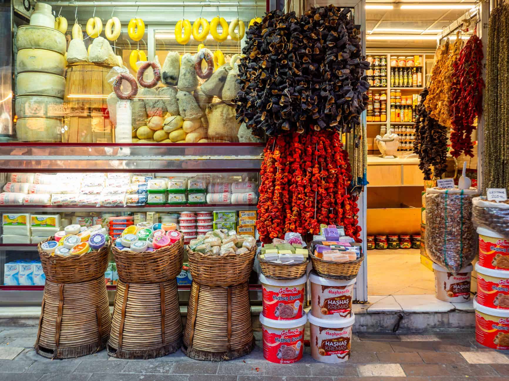 A colorful and vibrant display of spices, cheeses, and goods at a Turkish market.