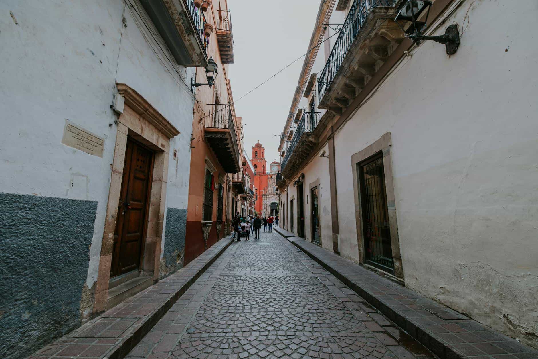 Picturesque cobblestone street in Guanajuato, Mexico showcasing colonial architecture.