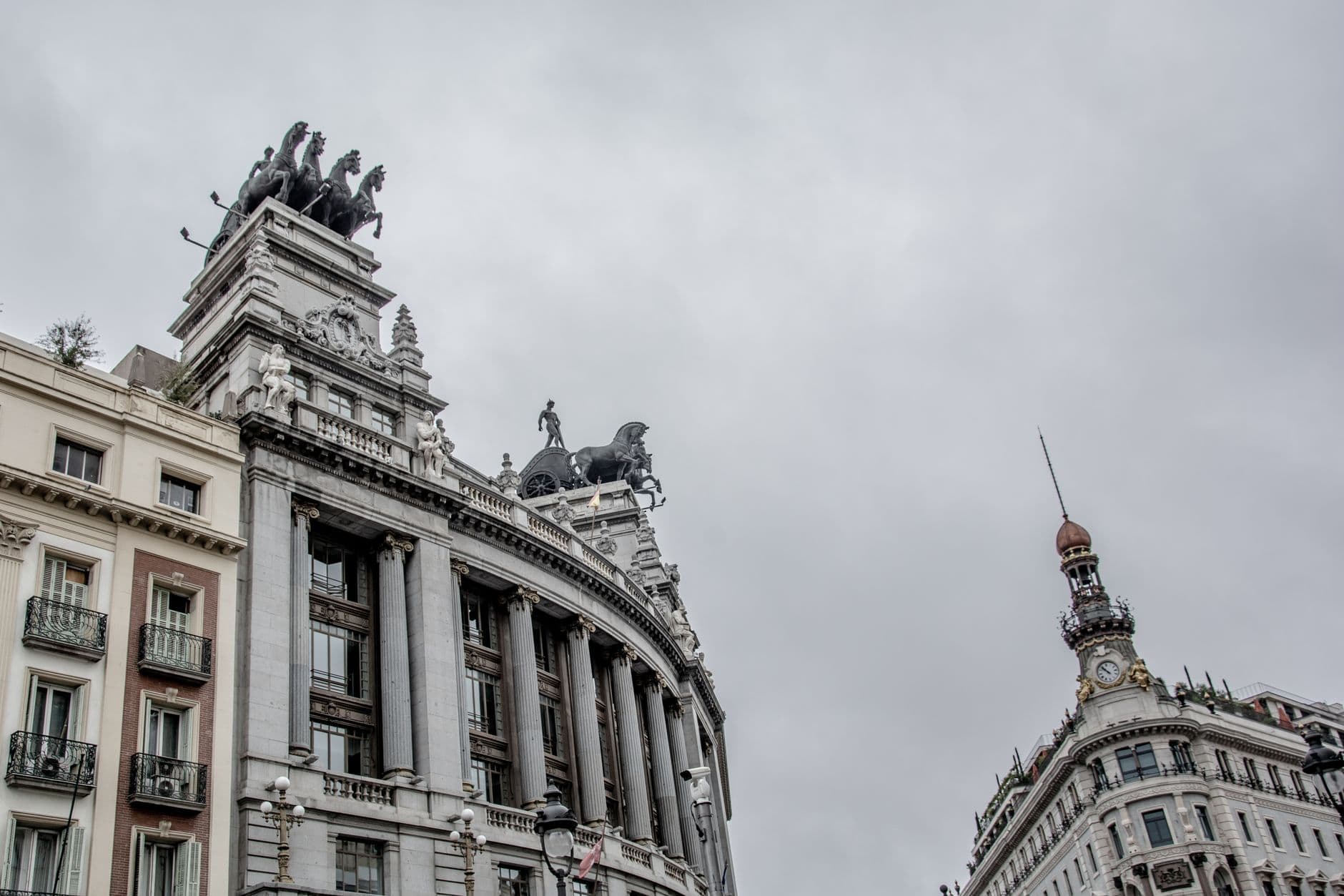 Low angle view of classical architecture with sculptures in Madrid, Spain.