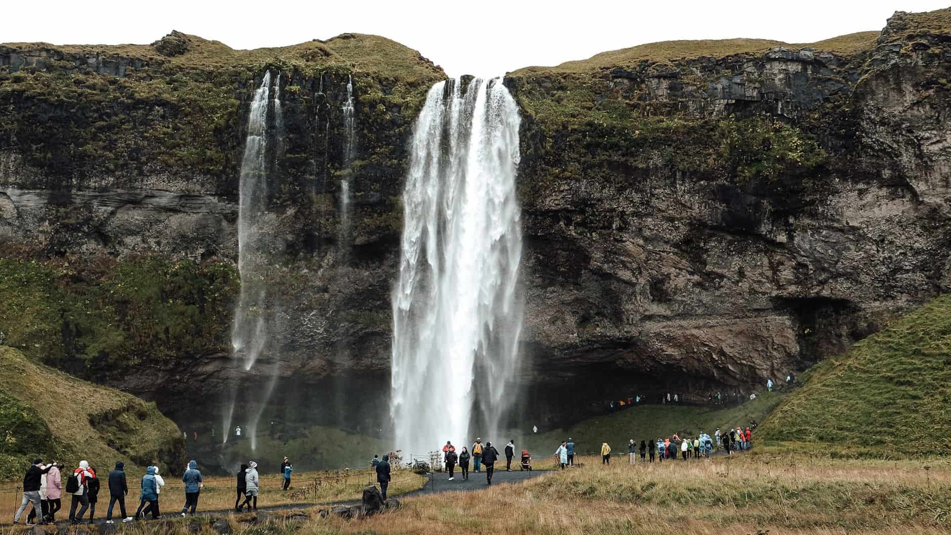 Iceland waterfall tourist crowd