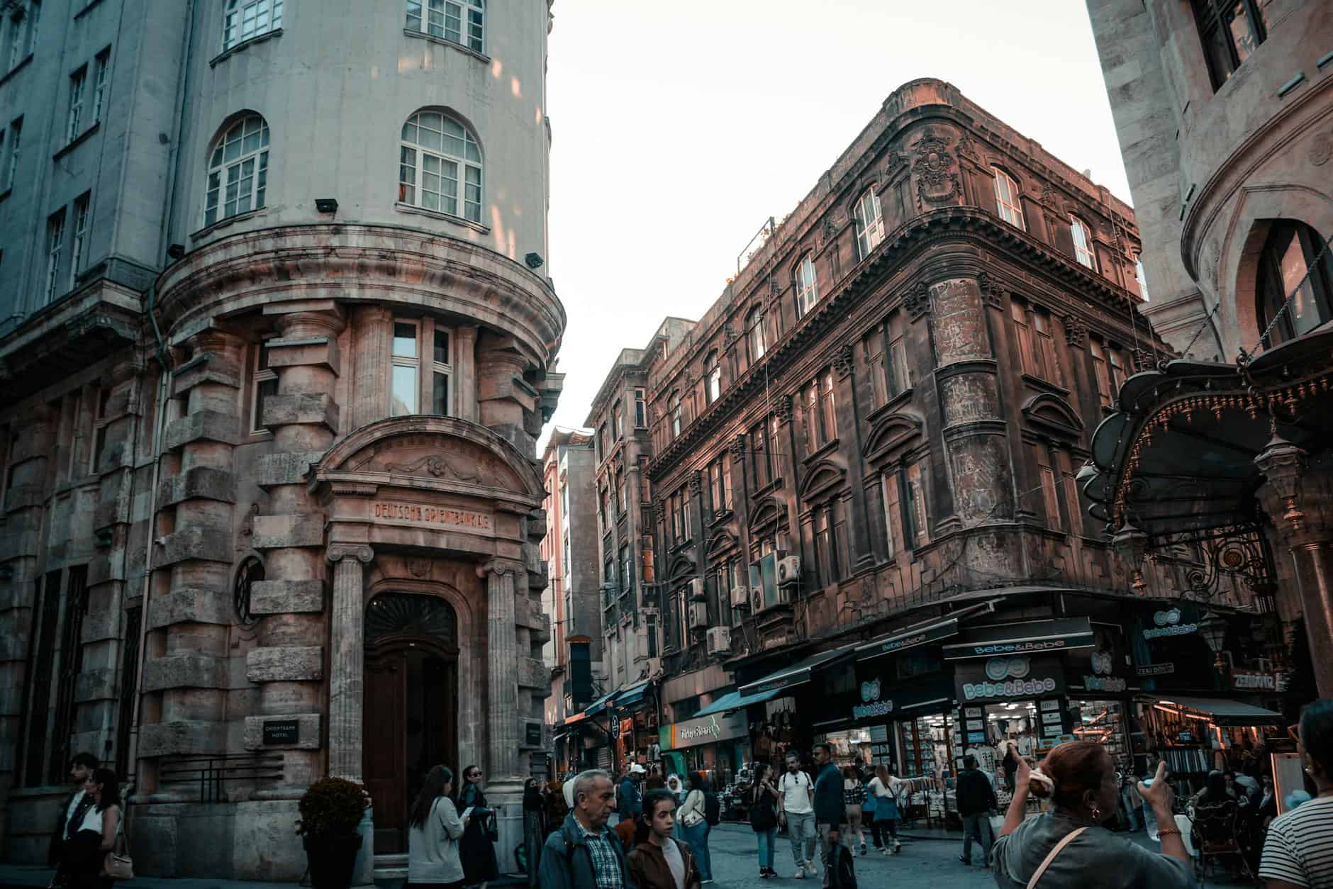 A busy street with historic European buildings and people passing by, showcasing urban lifestyle.