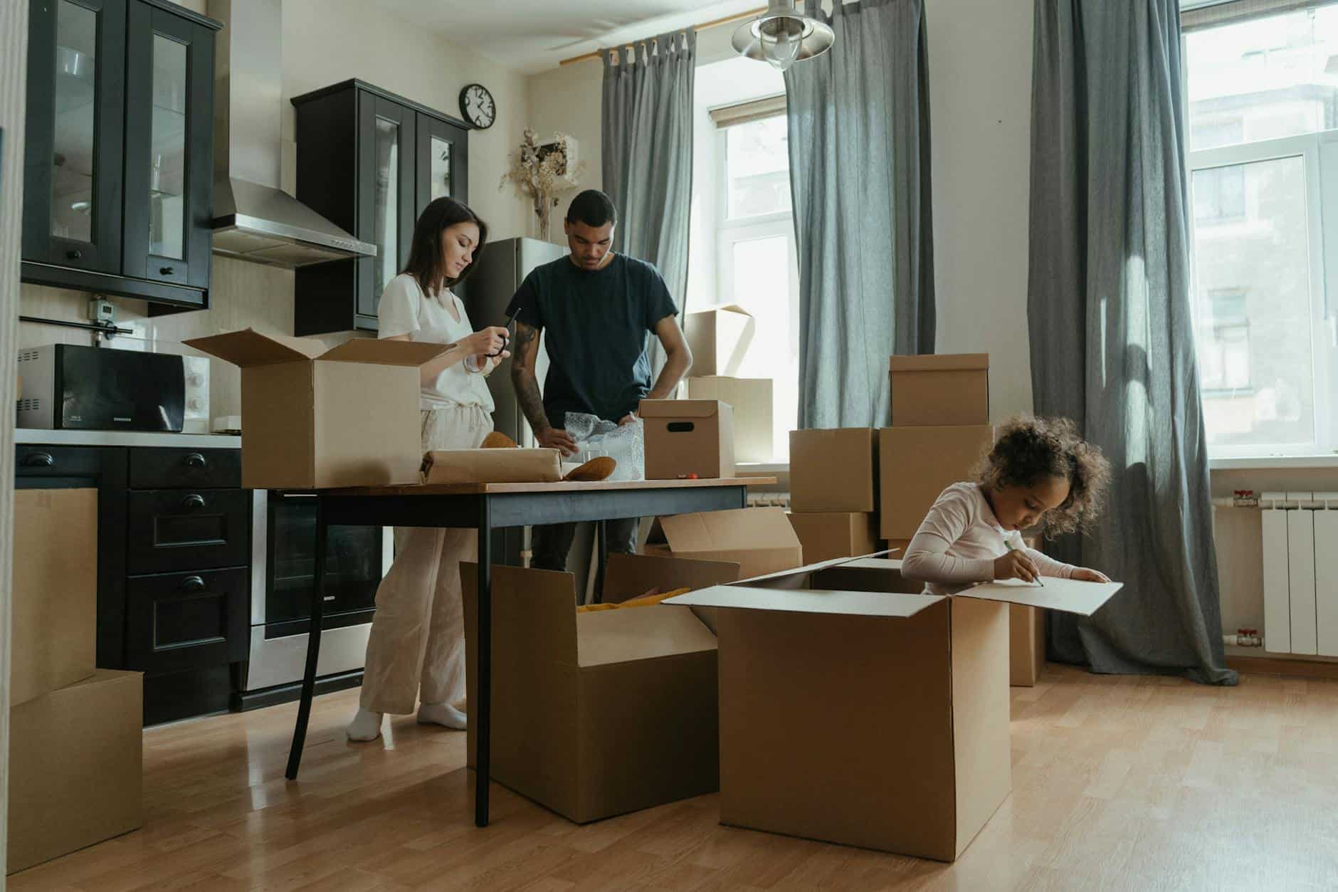 family packing moving boxes