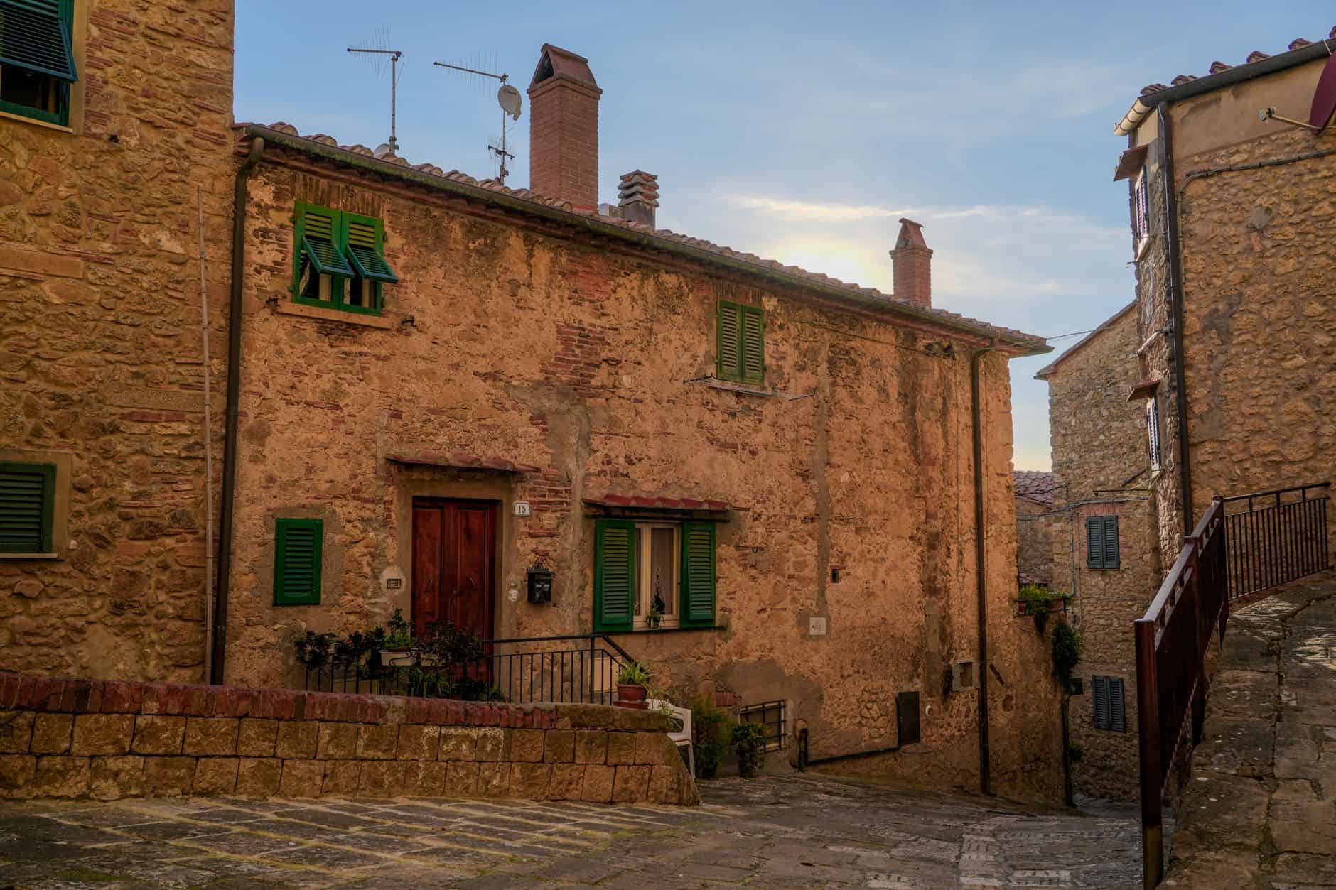 Cobblestone street in Casale Marittimo, showcasing rustic architecture and a serene Tuscan village ambiance.
