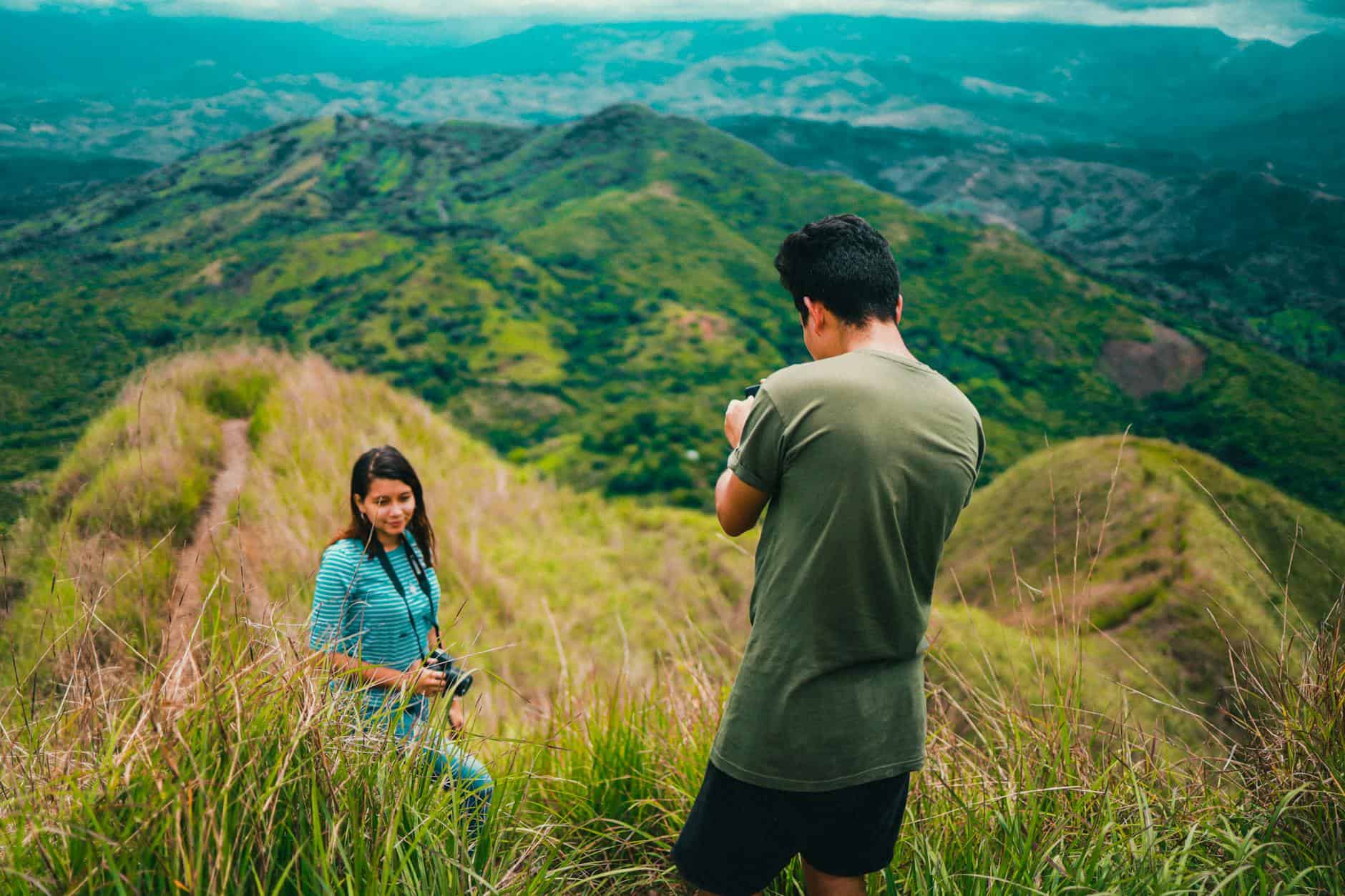 man photographing woman travel